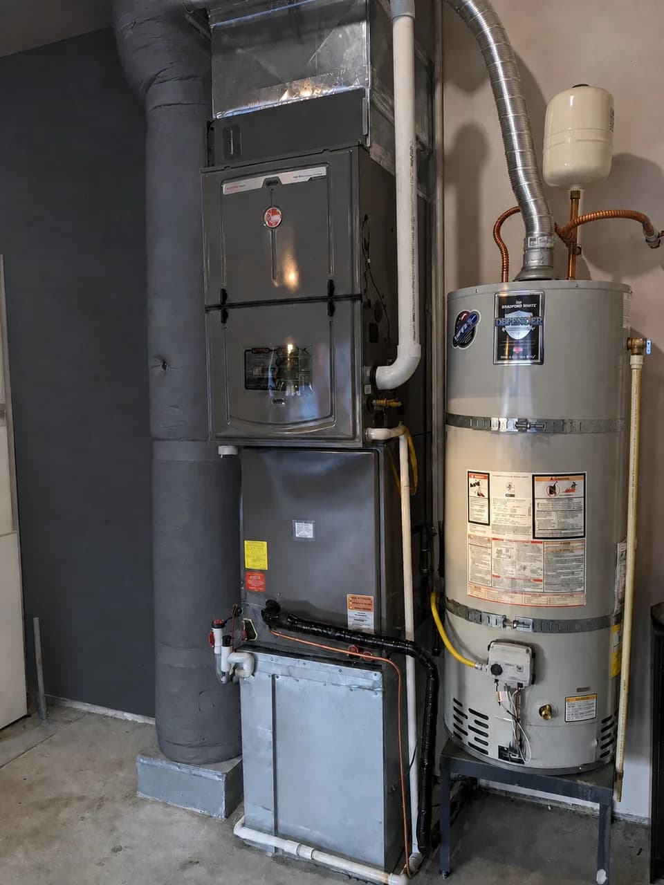 Furnace and water heater installed together in a residential mechanical space