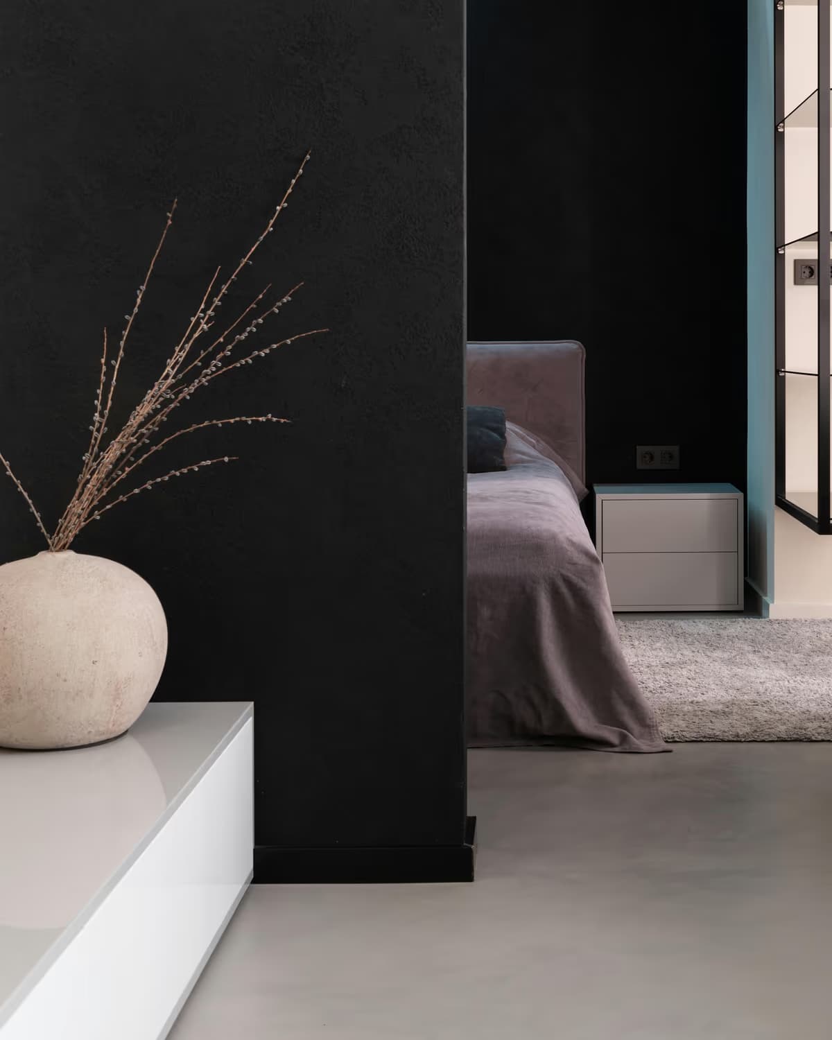 Dark modern bedroom interior with neutral furnishings
